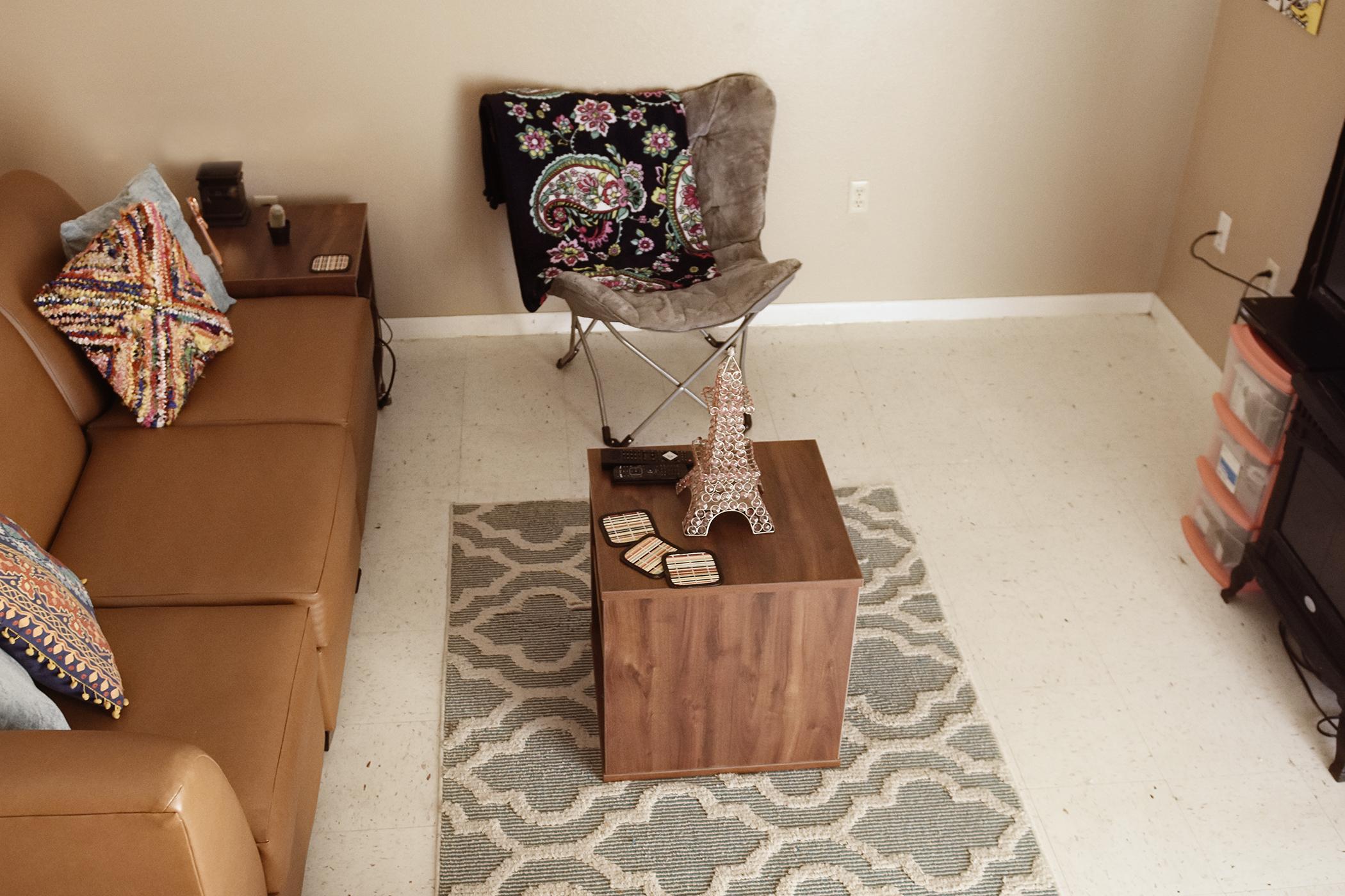 In the living room a sectional sofa and two end tables are provided.