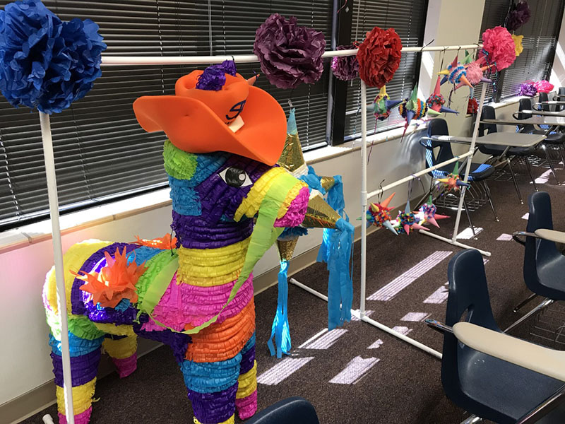 Students in Dr. Rios' HUMA 1305, Introduction to Mexican-American Studies, course make piñatas to learn about material culture. (Levelland Campus) 